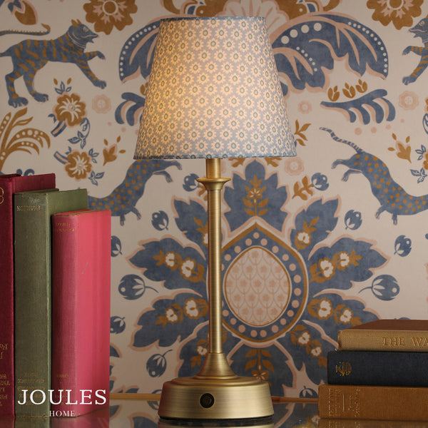 Joules Apsley rechargeable table lamp in matt antique brass with a blue floral print cotton shade
