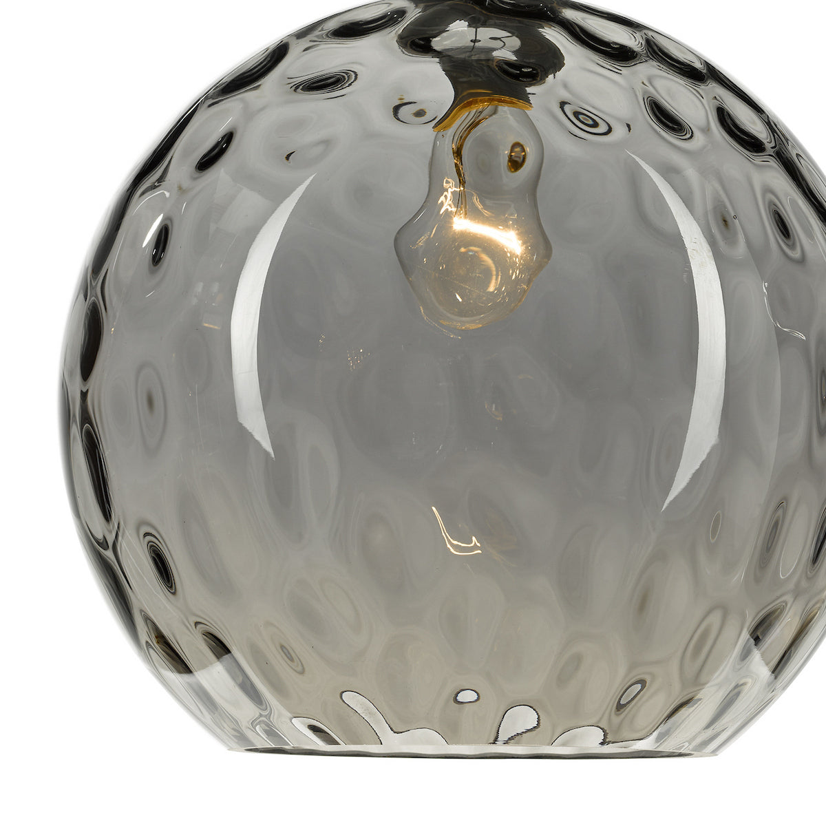 Close-up of a textured, smoked glass pendant light with a glowing bulb inside.