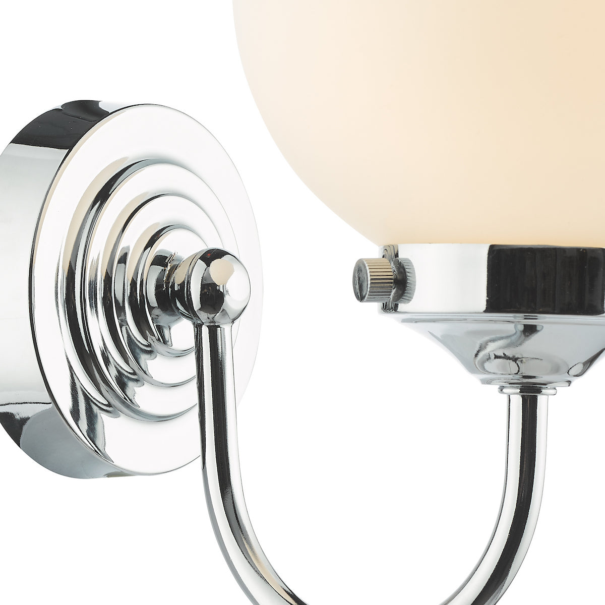 Close-up of a chrome wall sconce with a frosted glass globe shade.