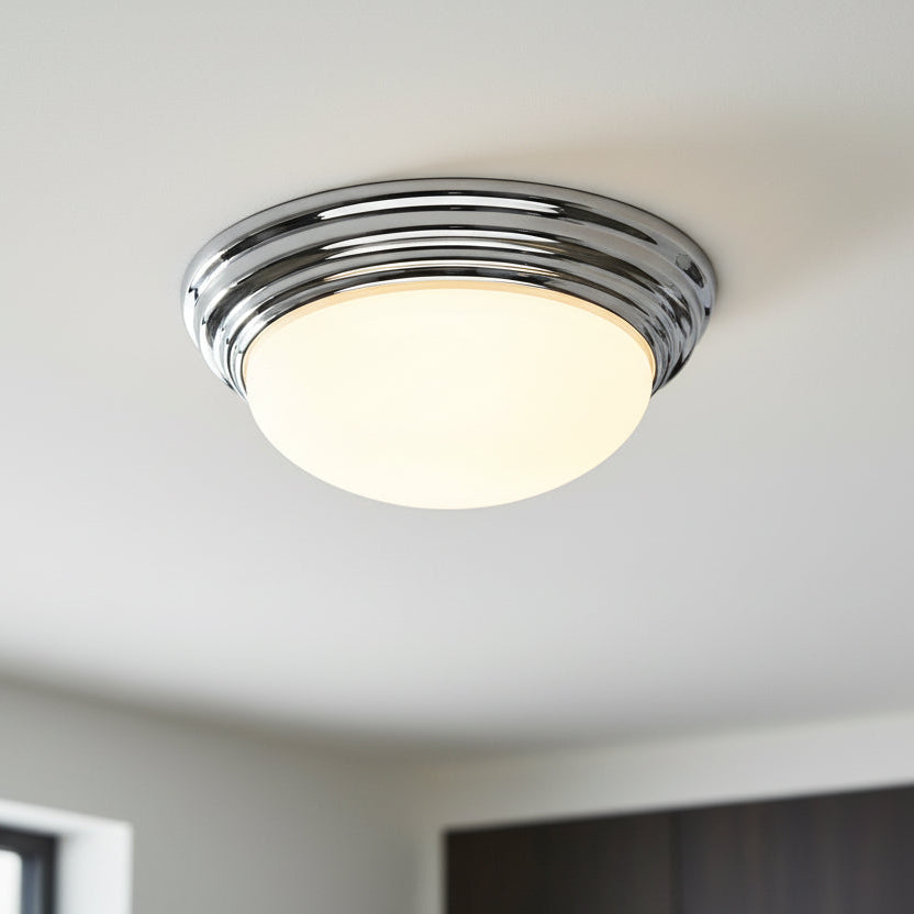 Chrome ceiling light with a round, frosted glass shade