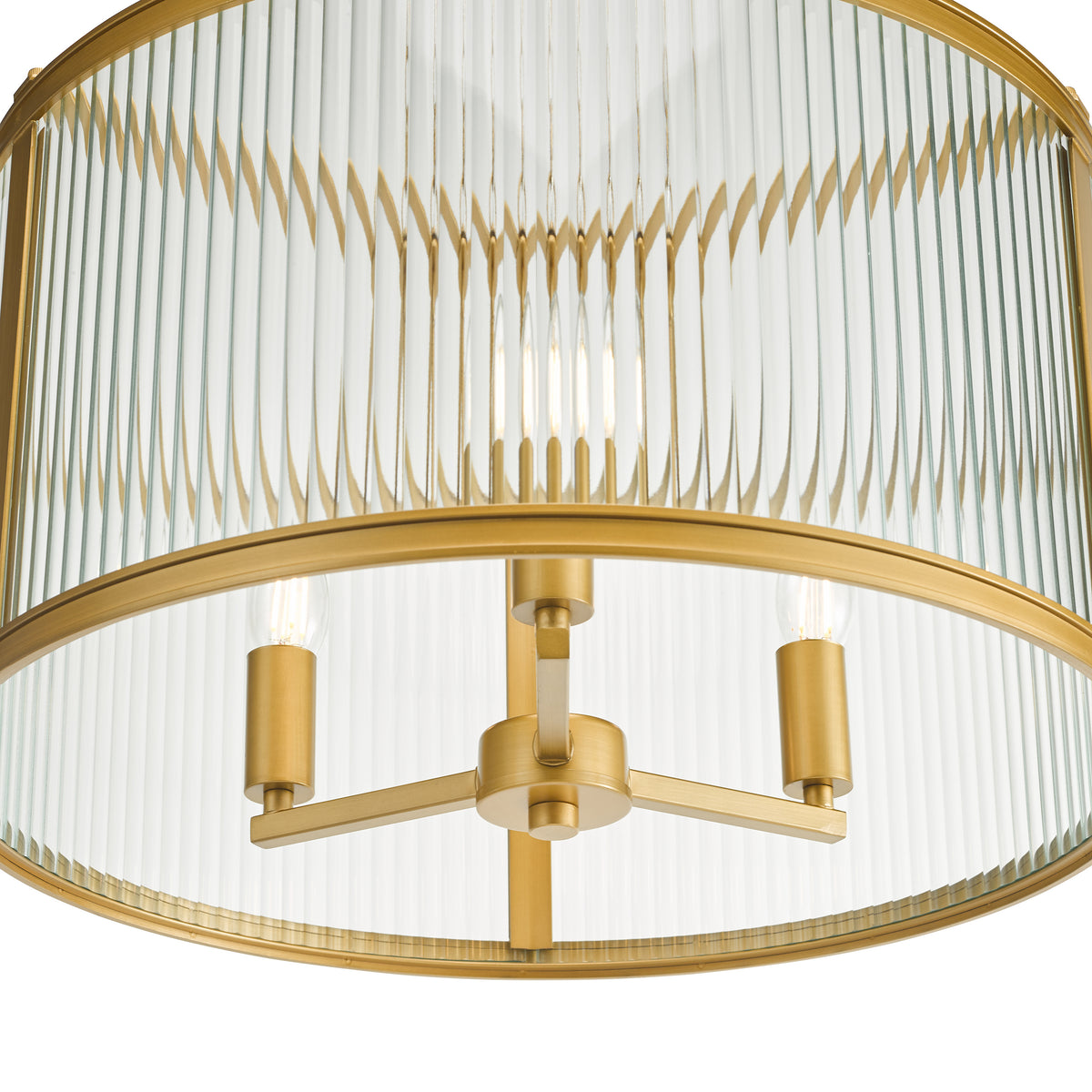 Close up of a gold and glass ceiling light with three bulbs
