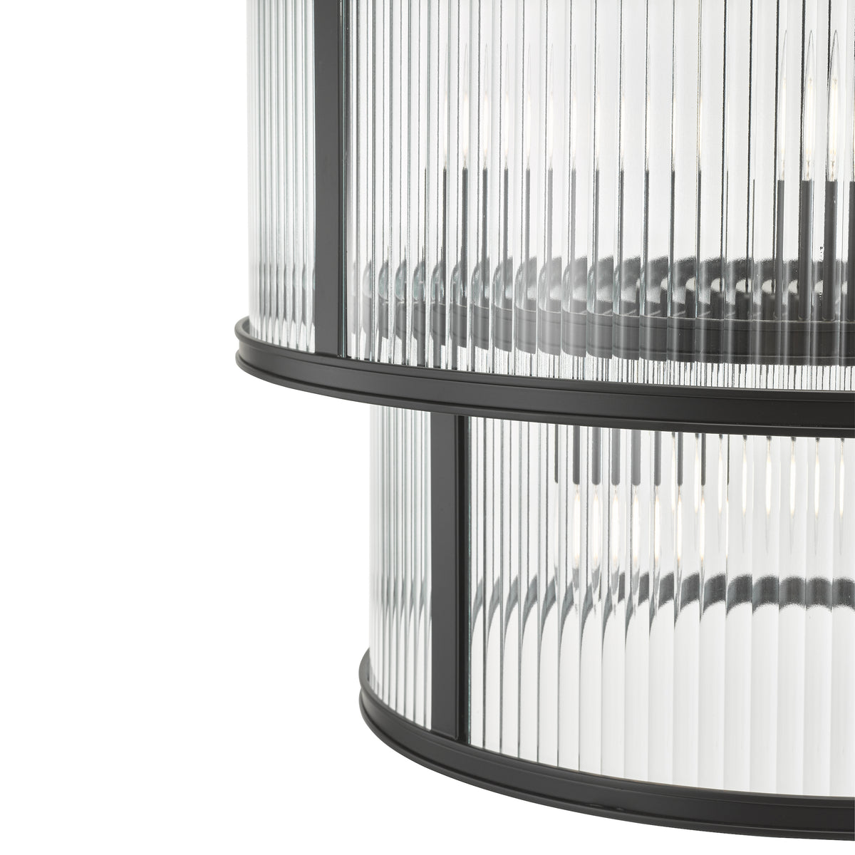 Close up of a two-tiered chandelier with fluted glass and black metal bands