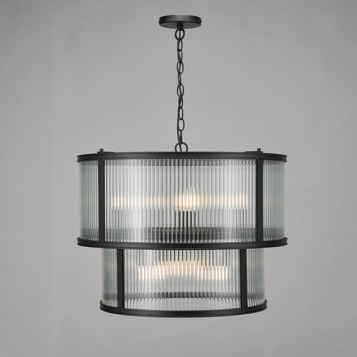 Two-tier chandelier with fluted glass shades and a black metal frame
