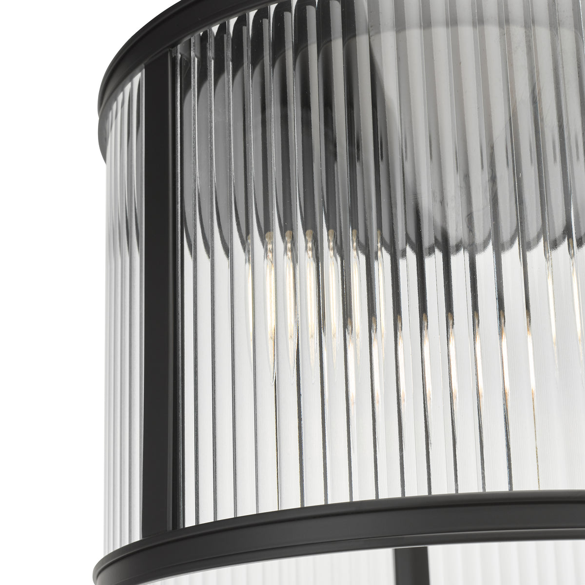 Close up of a black and clear glass pendant light with vertical fluted glass