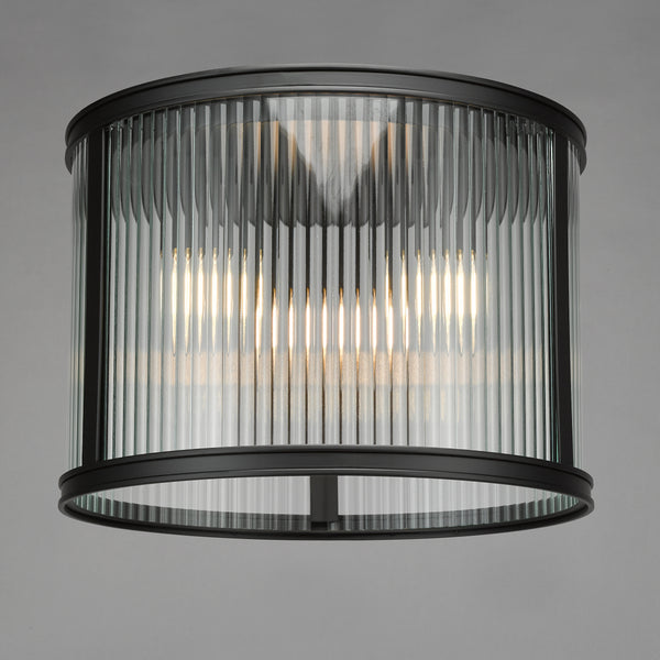 Round ceiling light with fluted glass shade and black metal frame
