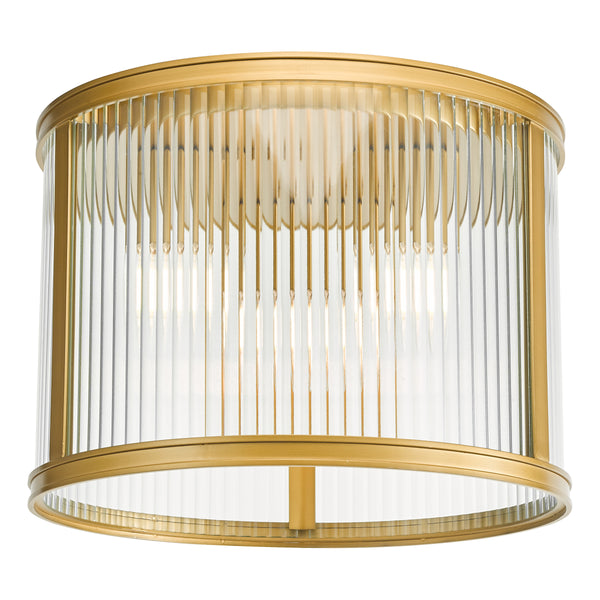 Round gold flush mount light with clear fluted glass shade