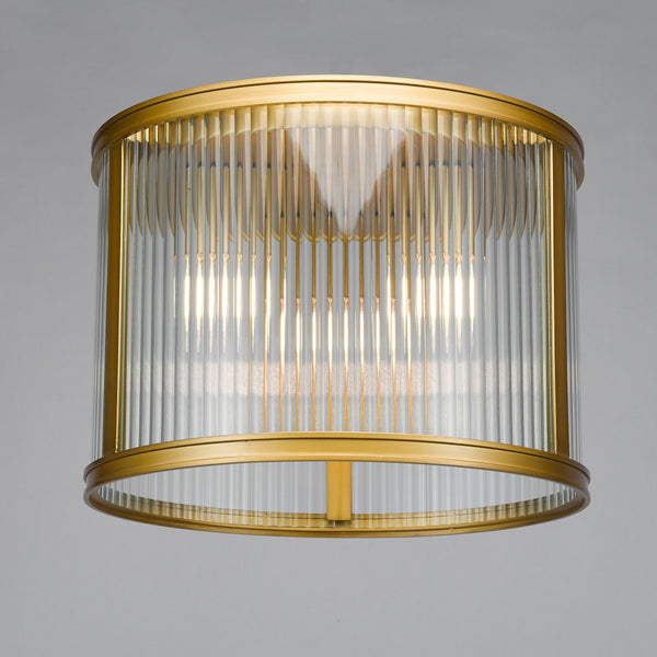 Cylindrical brass and fluted glass ceiling light with illuminated bulbs