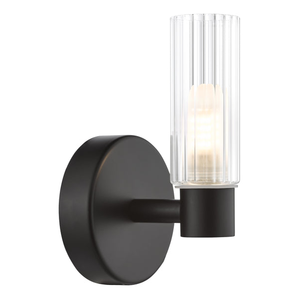 Black wall sconce with a clear fluted glass shade and an exposed bulb