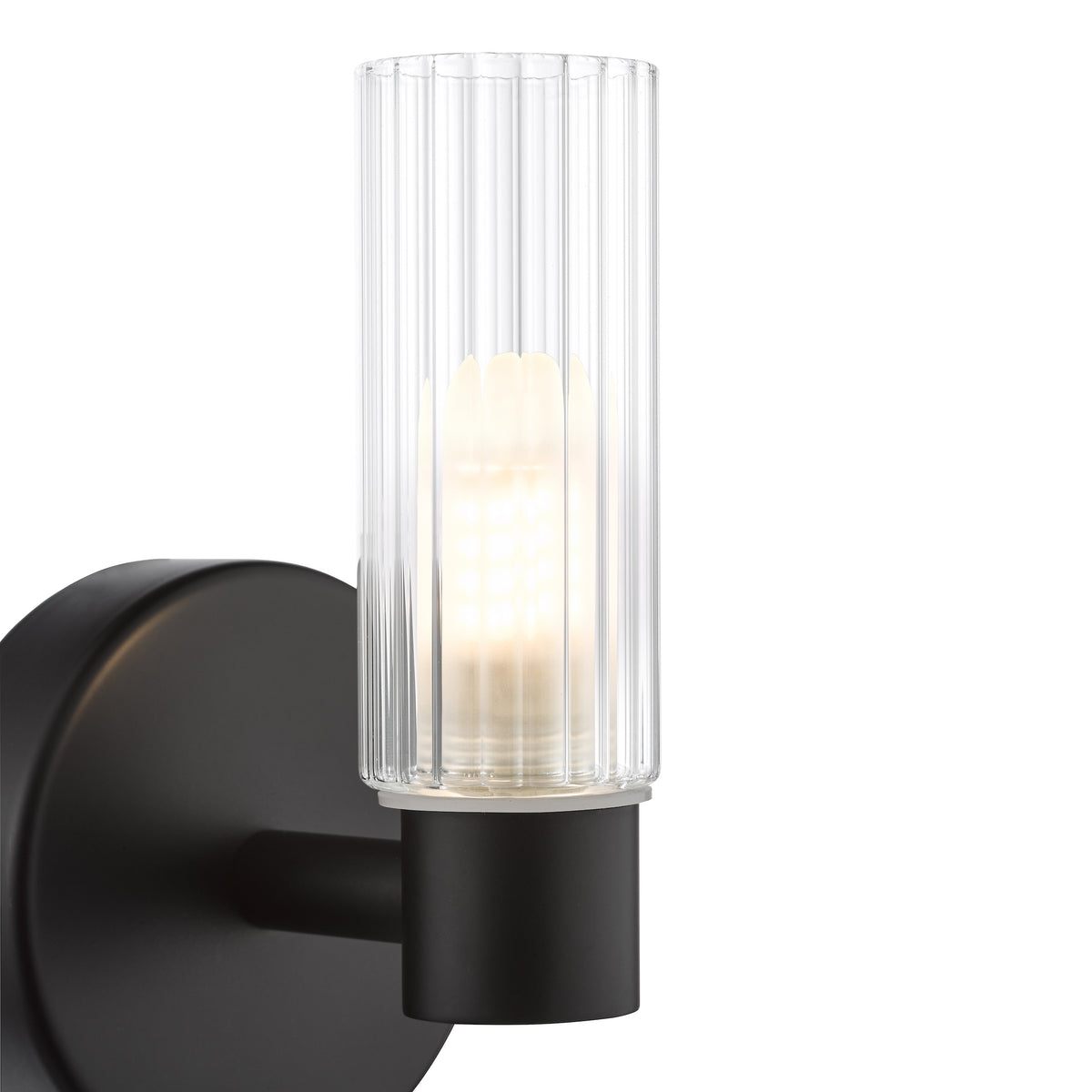 Black wall sconce with a clear ribbed glass shade and an illuminated bulb