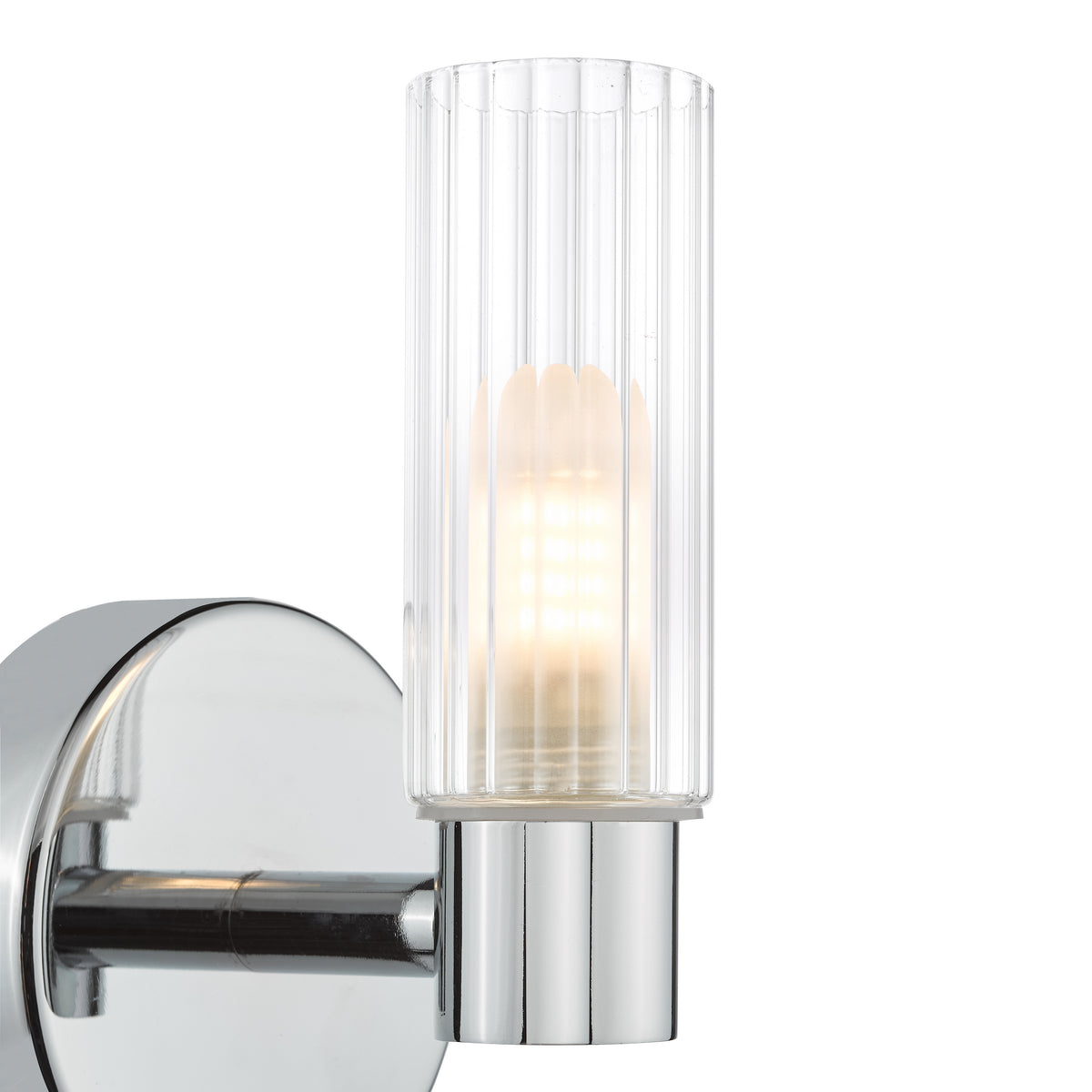 Chrome wall sconce with a ribbed glass shade and an illuminated bulb