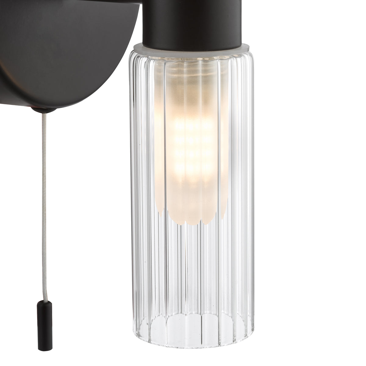 Black wall light with a ribbed glass shade and a pull cord switch