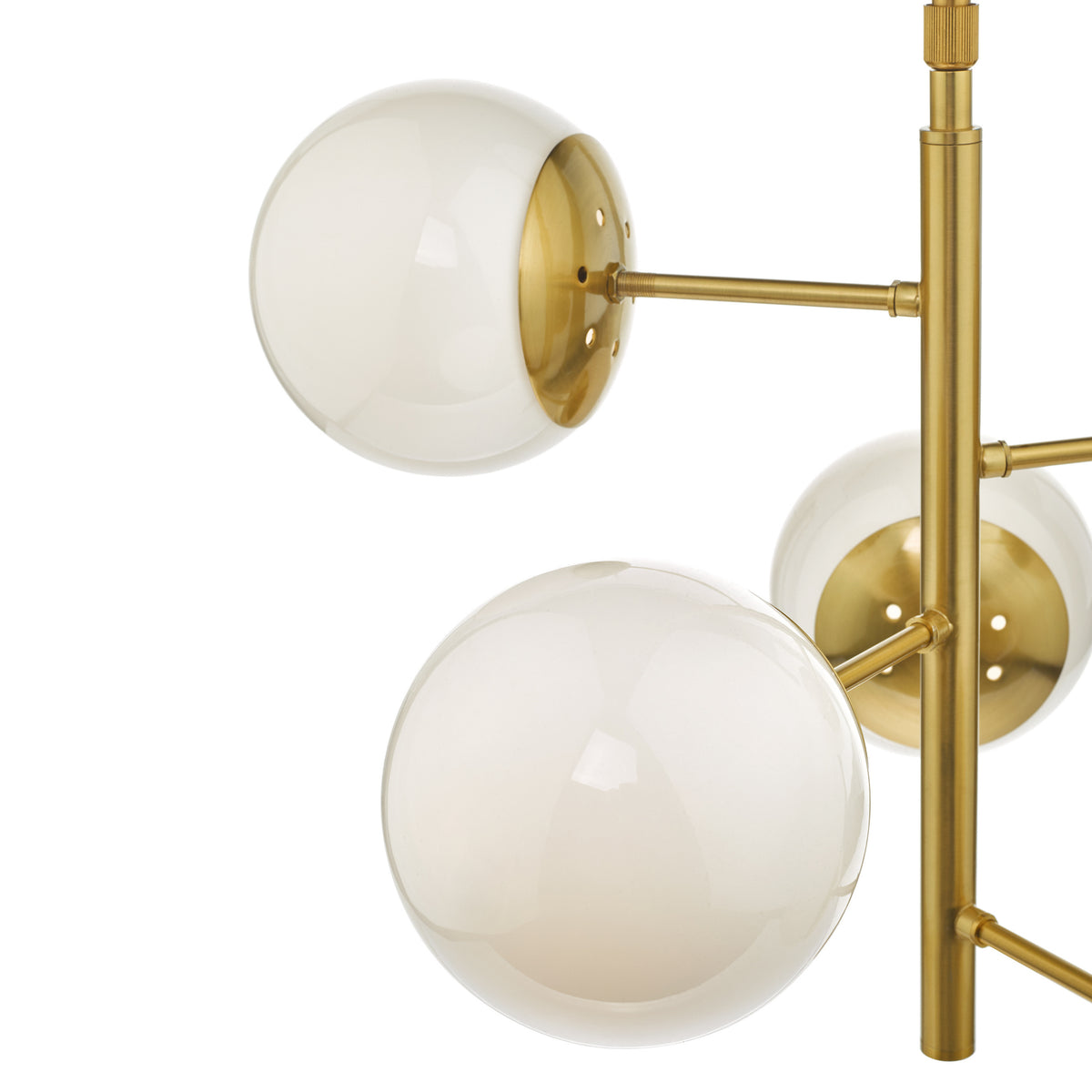 Close up of a brass chandelier with three white glass globes