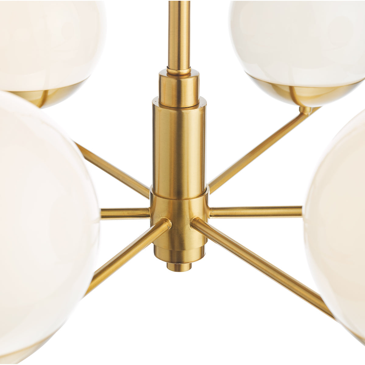 Close-up of a brass chandelier with multiple white spherical globes.
