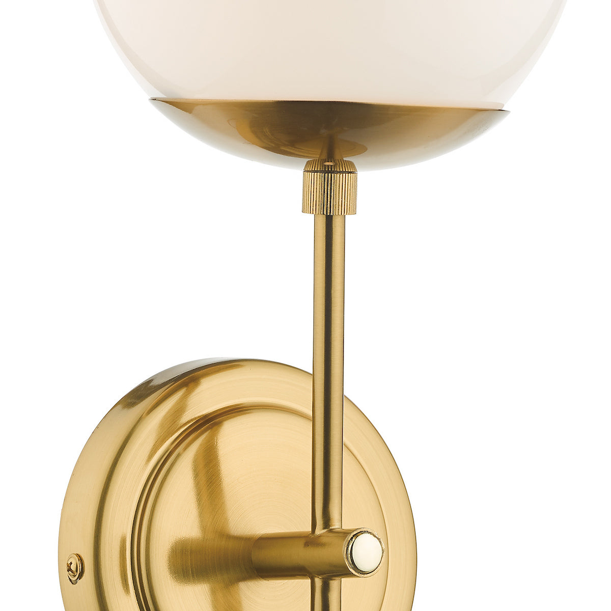 Close up of a brass wall sconce with a white globe light