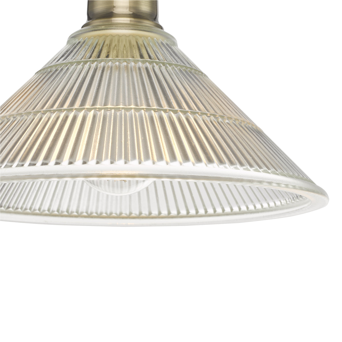Close up of a clear ribbed glass lampshade with a metal fixture