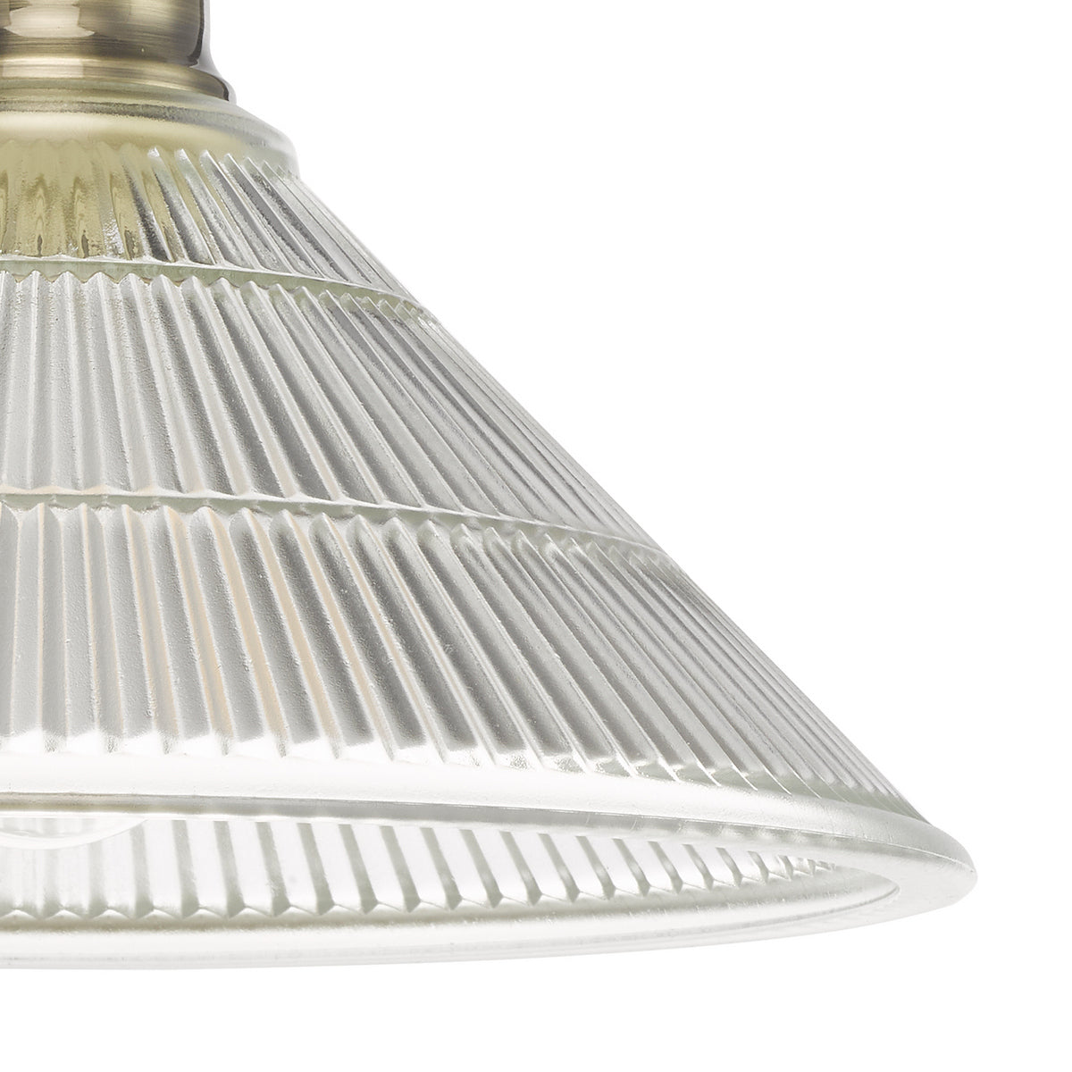 Close up of a clear glass conical light shade with vertical ridges