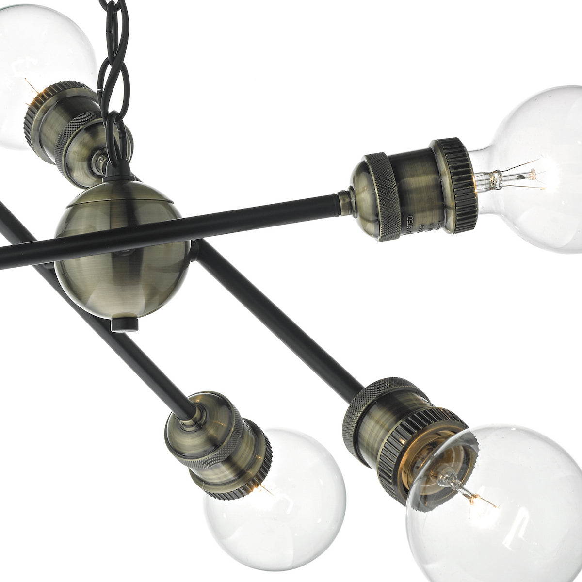 Close-up of a modern chandelier with exposed bulbs and antique brass accents.