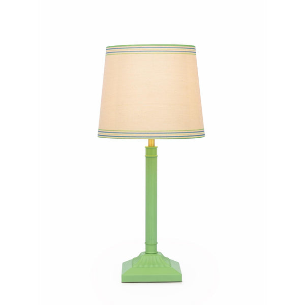Green table lamp with a beige fabric shade featuring blue and green striped trim