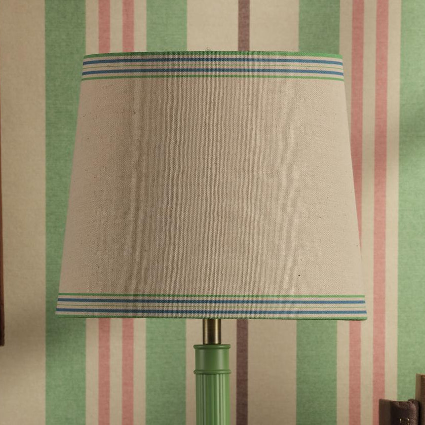 Tapered lampshade with beige fabric and blue and green striped trim
