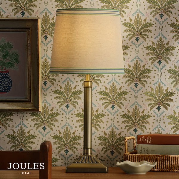 Joules Buscot table lamp with antique brass base and tapered linen shade with blue and green striped trim