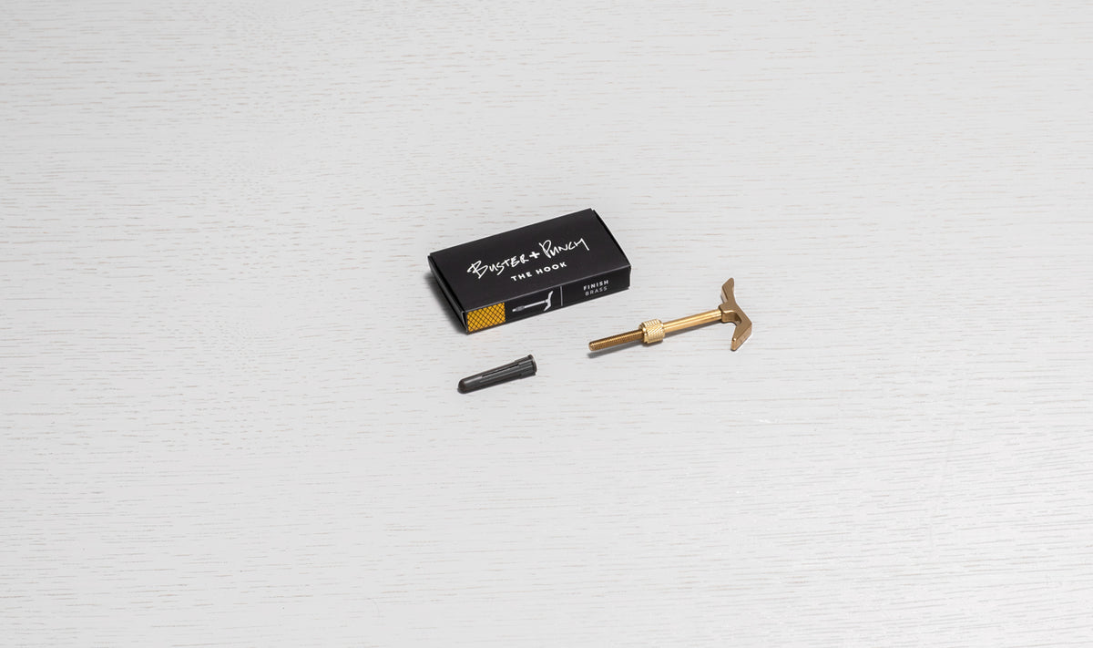 Buster + Punch The Hook in brass finish, with a wall plug and packaging