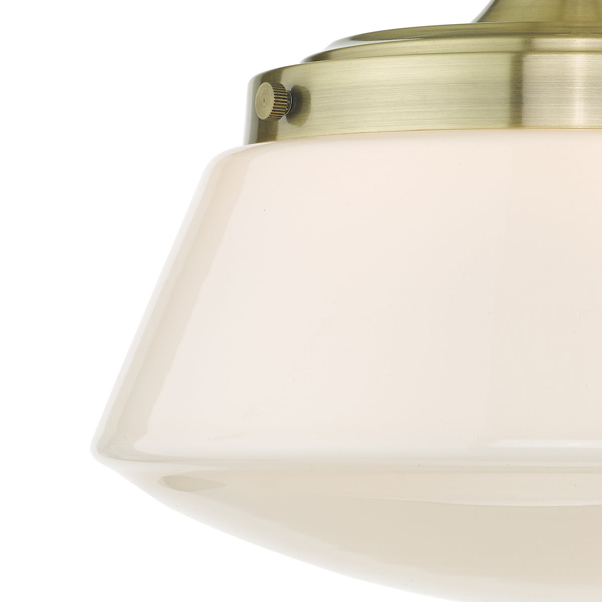 Close up of a cream glass light shade with a brass fitting