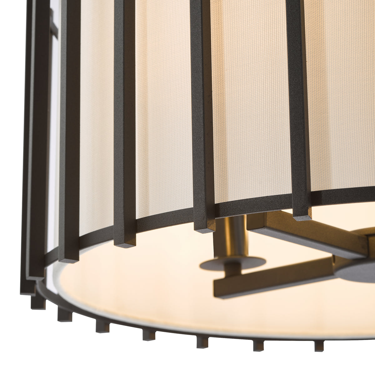 Close up of a black metal chandelier with a white fabric shade