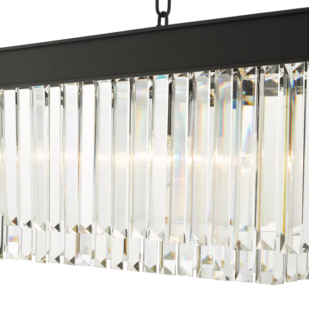 Close up of a rectangular chandelier with a black frame and two rows of clear crystal prisms