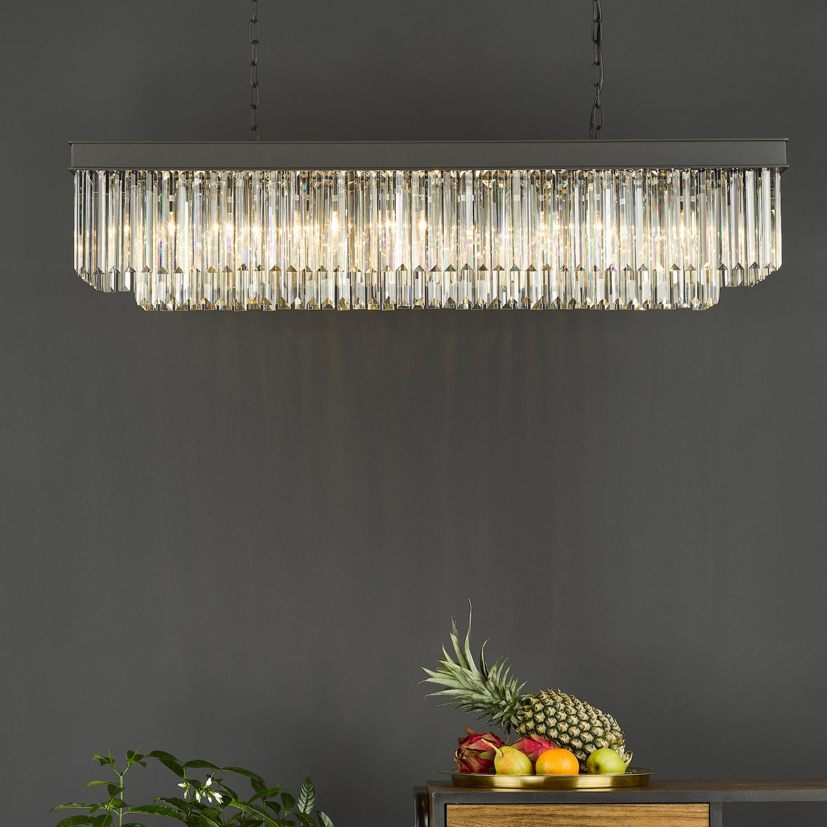 Rectangular crystal chandelier with multiple vertical crystal rods and a dark metal frame