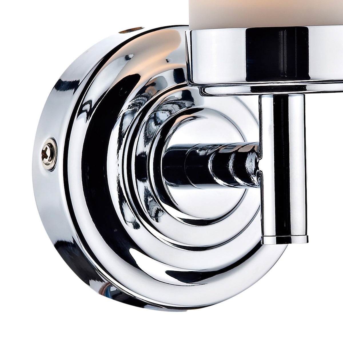 Close-up of a chrome wall sconce with a round base and a cylindrical arm holding a light.