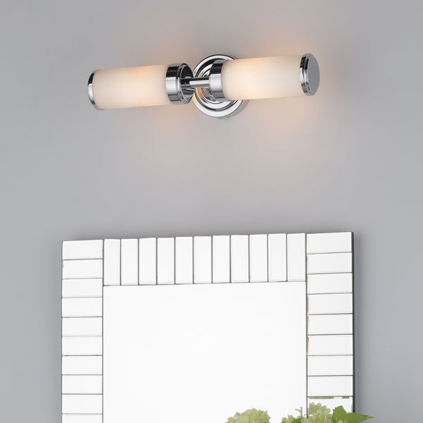 Two-light vanity fixture with chrome finish and frosted glass shades above a rectangular mirror.