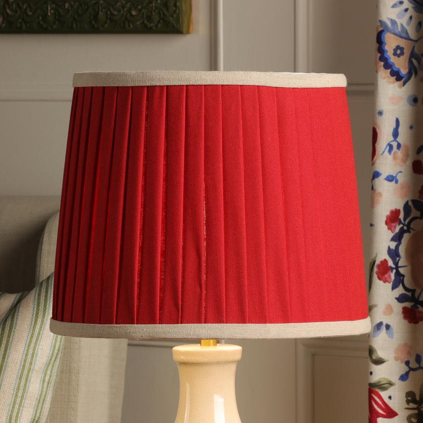 Joules Chatsworth ceramic table lamp with a cream base and pleated red linen shade