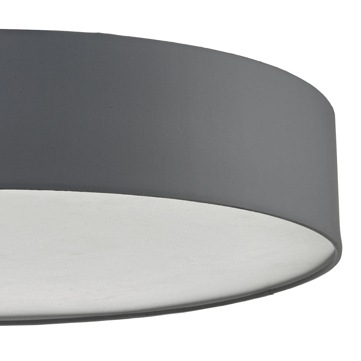Close-up of a dark gray drum lampshade with a white interior.