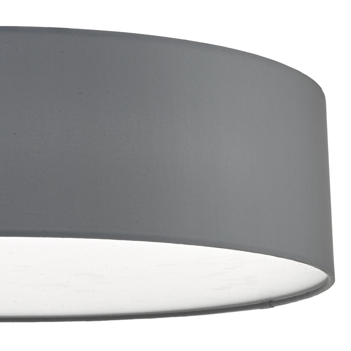 Close-up of a gray drum lampshade with a white diffuser at the bottom.