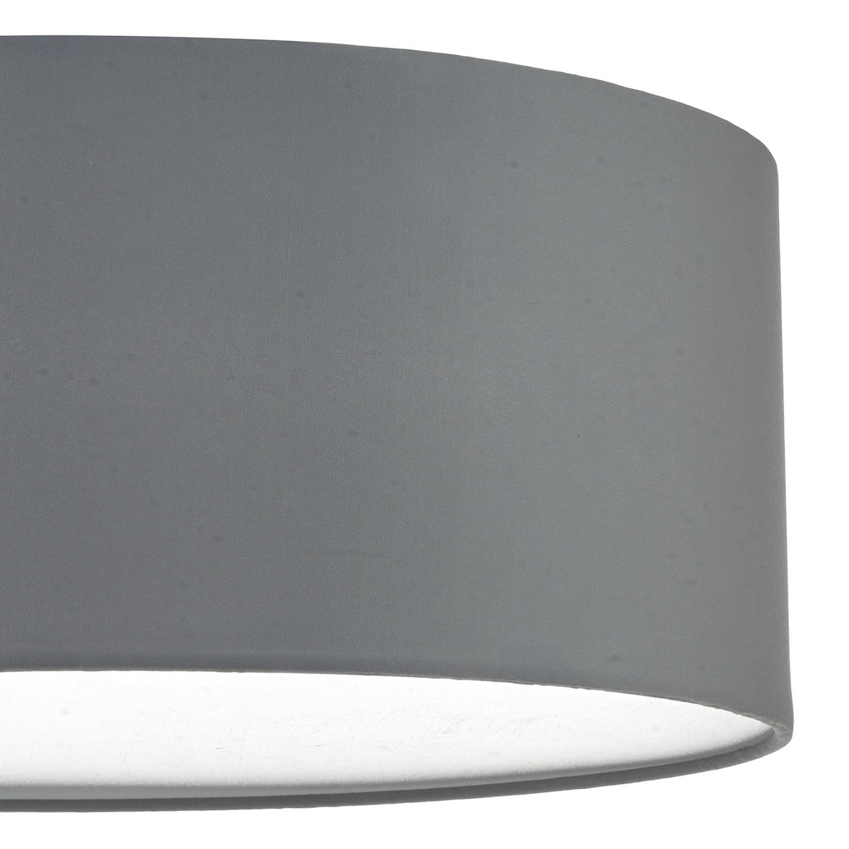 Close-up of a gray cylindrical lampshade with light emanating from the bottom.