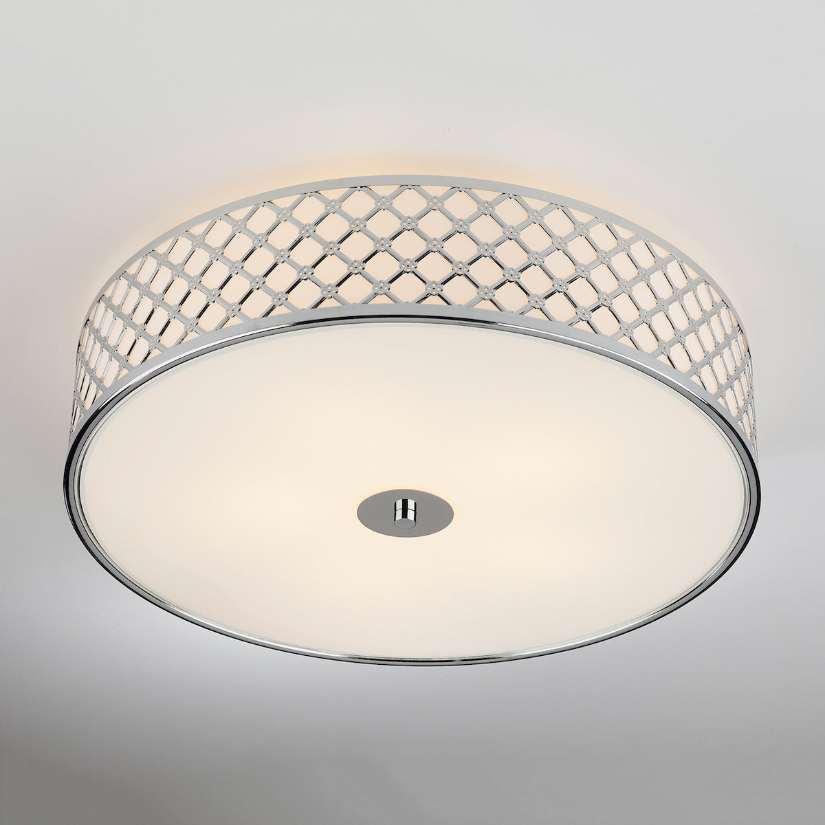 Round ceiling light with a chrome lattice pattern and a white diffuser.