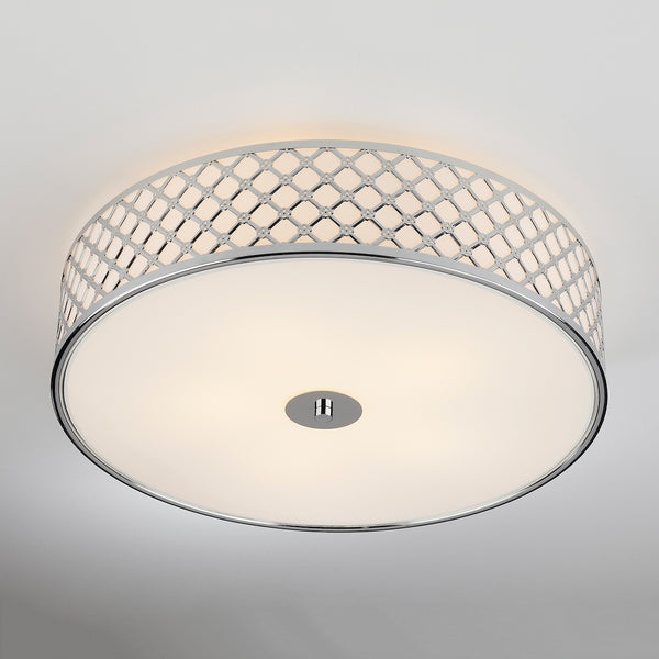 Round ceiling light with a chrome lattice pattern and a white diffuser.