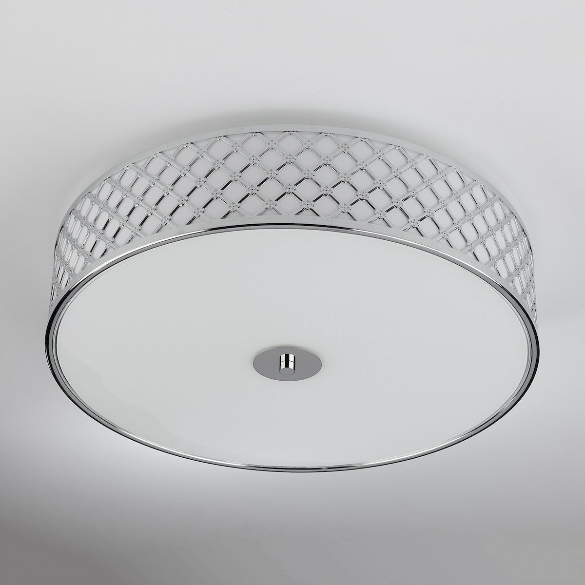 Round ceiling light with a chrome finish and a decorative patterned band.