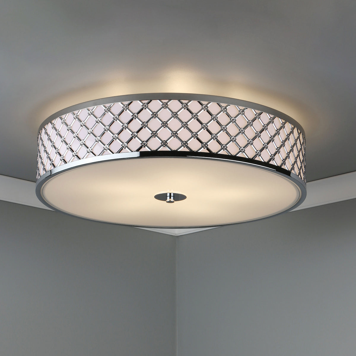 Round ceiling light with a chrome finish and a decorative band of crisscross patterns.