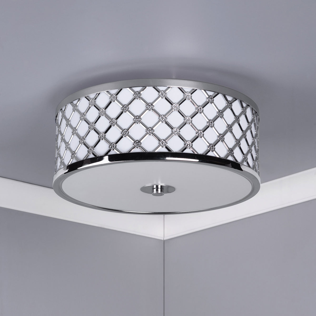 Round ceiling light with a chrome finish and a decorative diamond pattern with small floral accents.