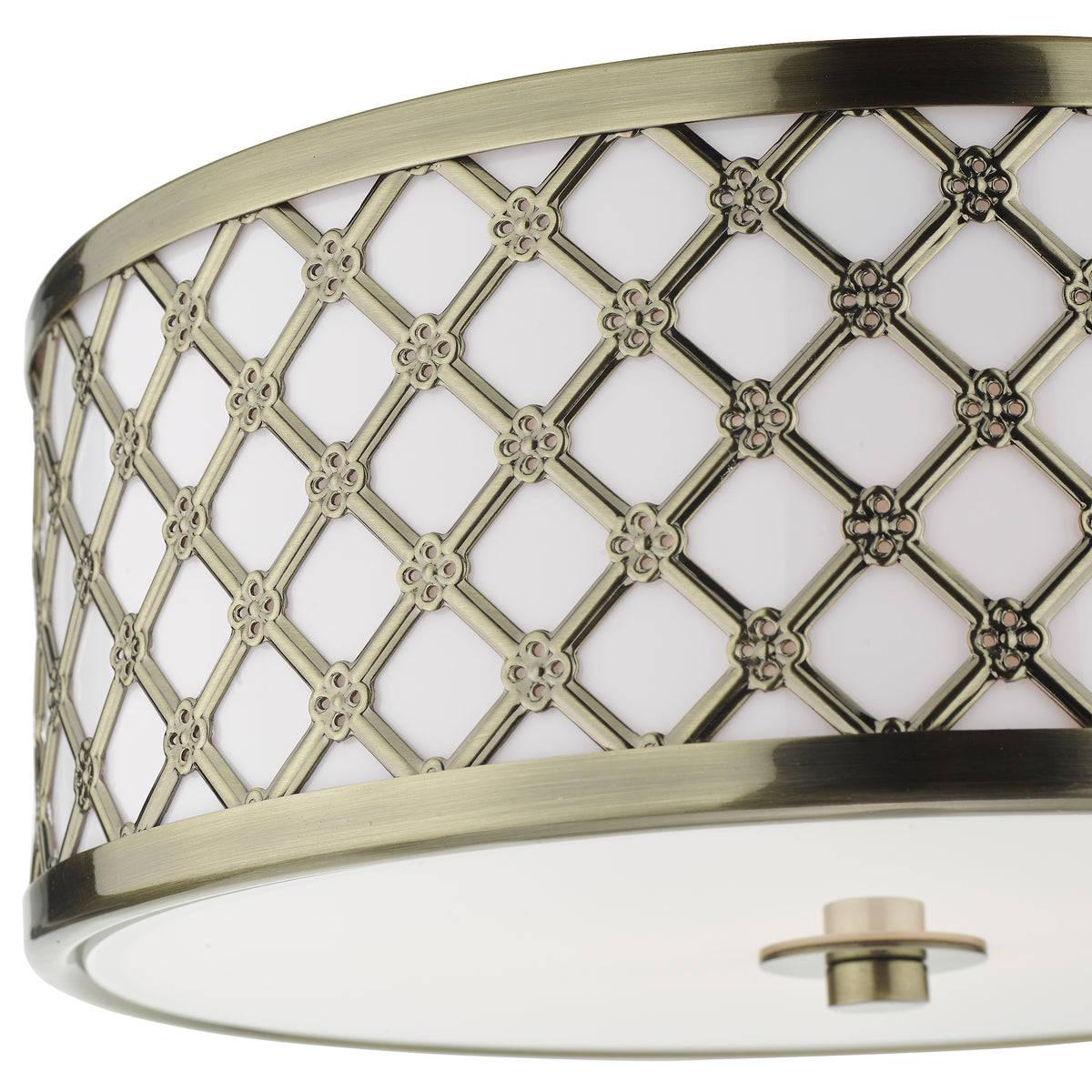 Close-up of a ceiling light with an antique brass finish and decorative lattice pattern.