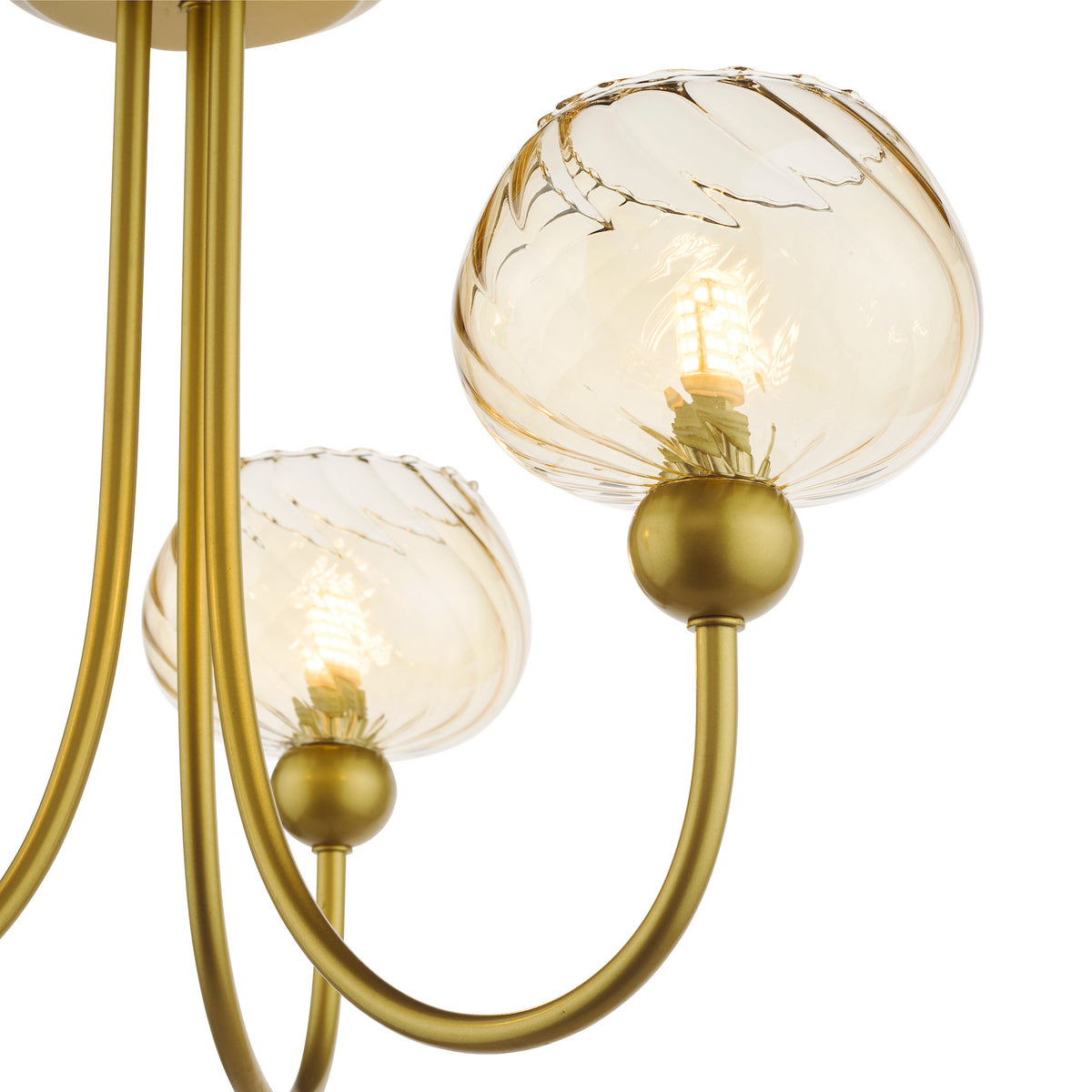 Close up of a gold chandelier with two amber glass shades and exposed bulbs