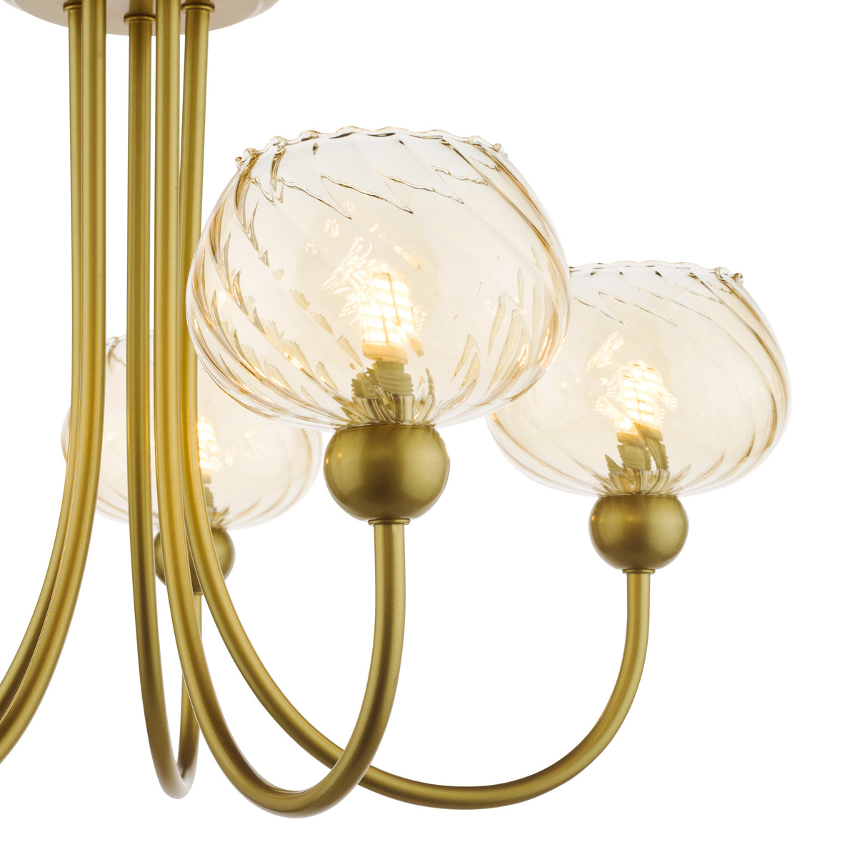 Close up of a gold chandelier with three amber glass shades