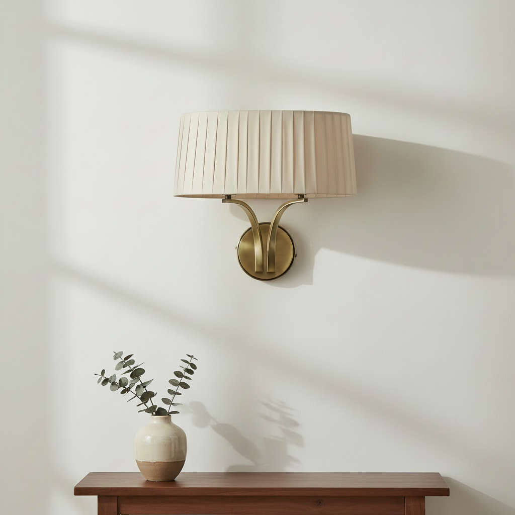 Pleated fabric shade wall sconce with a brass base