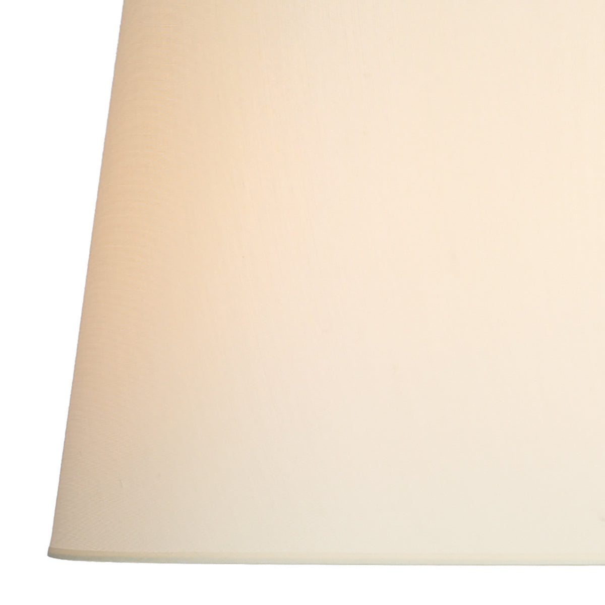 Close-up of a cream-colored fabric lampshade with a subtle texture.