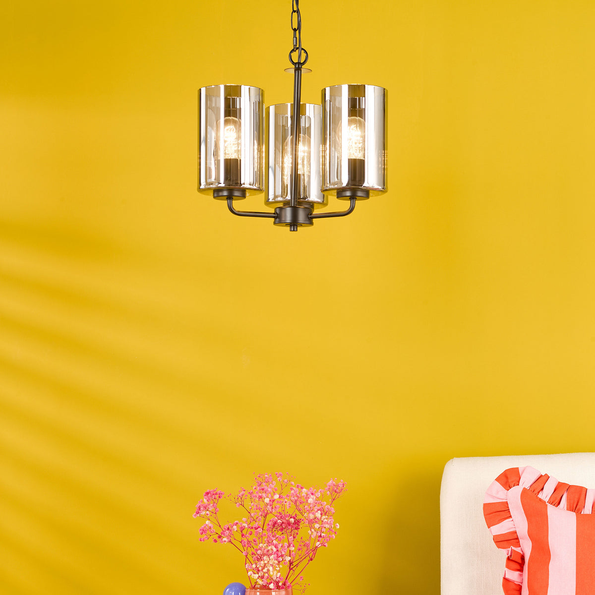 Three-light chandelier with clear glass shades and dark bronze finish