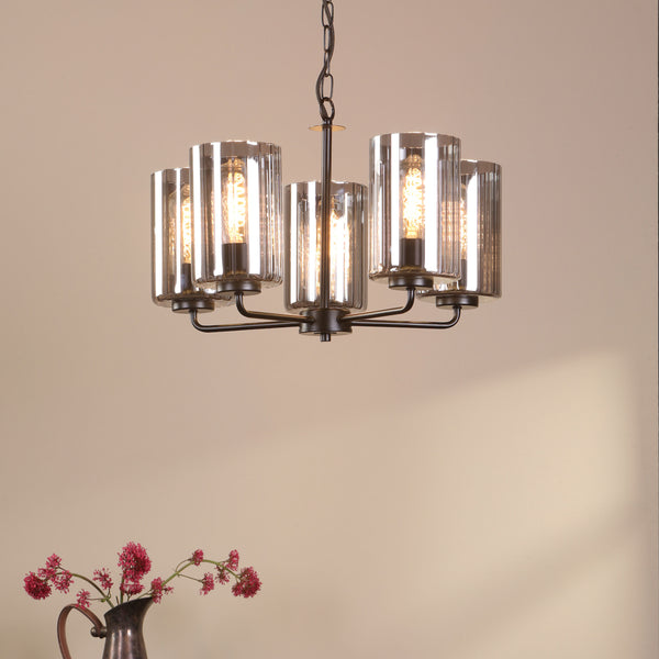 Five-light chandelier with clear glass shades and exposed filament bulbs