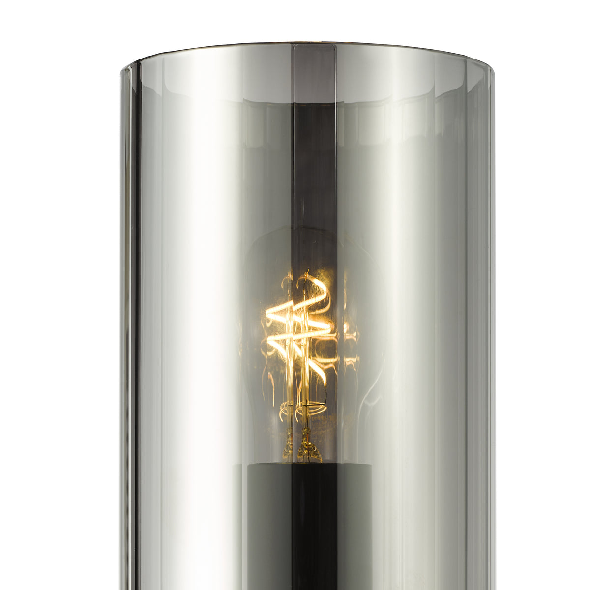 Close up of a lit filament bulb inside a cylindrical smoked glass shade