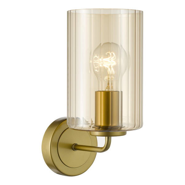Gold wall sconce with a ribbed amber glass shade and an exposed light bulb