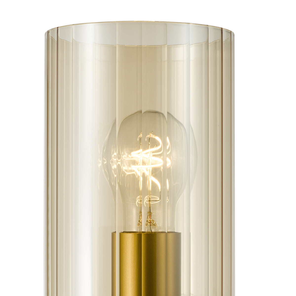 Close up of a lit lightbulb inside a fluted glass shade with a gold base